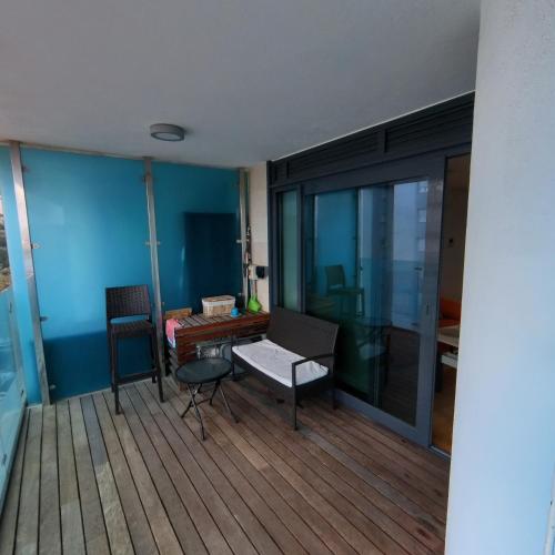 a room with a balcony with a table and a chair at OCEAN SPA Suite 11-Hosted by Sweetstay in Gibraltar