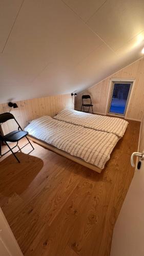 a large bed in a room with a wooden floor at Perfect winterhouse in Sälen in Sälen