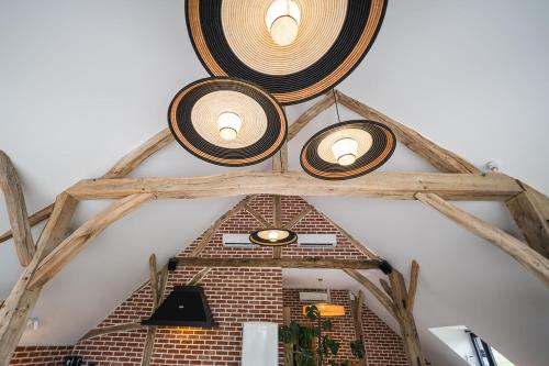 a group of lights on the ceiling of a room at Charmantes Maisons avec spas privatifs au calme Idéal weekend à 2 en famille ou entres amis in Vierzon