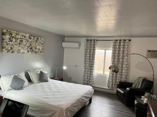 a bedroom with a large white bed and a window at Rainbow Mountain Resort - LGBTQ Friendly in East Stroudsburg