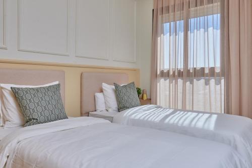 two beds sitting next to each other in a bedroom at YourPlace Rabat - Royal Residence in Rabat