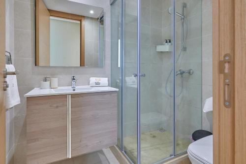 a bathroom with a shower and a sink and a toilet at YourPlace Rabat - Royal Residence in Rabat