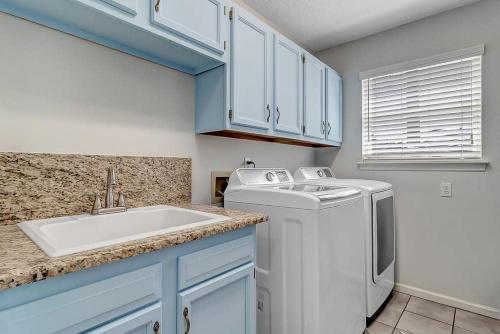 a kitchen with a washing machine and a sink at Stunning Ocean Villa-Luxurious Ponte Vedra Living in Jacksonville Beach