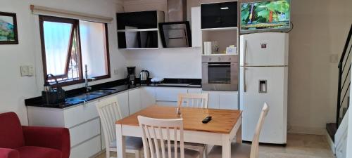 a small kitchen with a table and a refrigerator at DUPLEX in Gualeguay