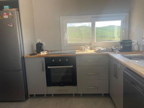 a kitchen with a stove and a sink and a window at Ecological Lake House in Seferihisar