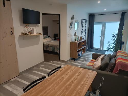 a living room with a couch and a table at Comme à la maison in Gannat