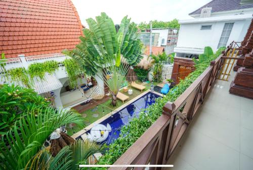 an overhead view of a balcony with a swimming pool at Shortcut Breeze Guest House in Canggu