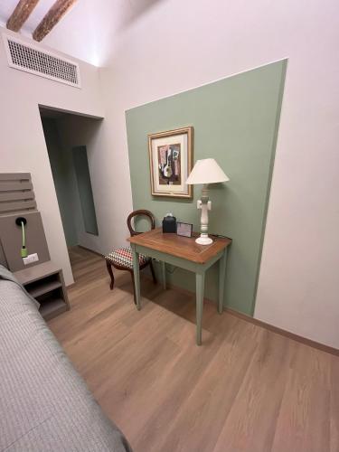 a room with a desk and a lamp on a table at Borgo35 in Parma