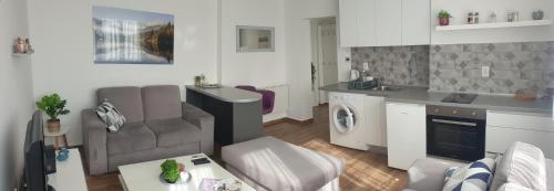 a kitchen with a sink and a washing machine at Apartman Klara in Osijek