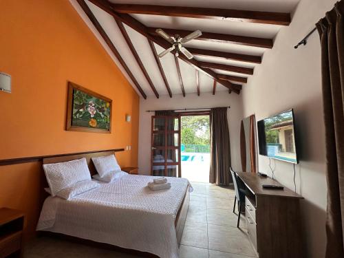 a bedroom with a bed and a desk in a room at Finca del Bosque in Montenegro