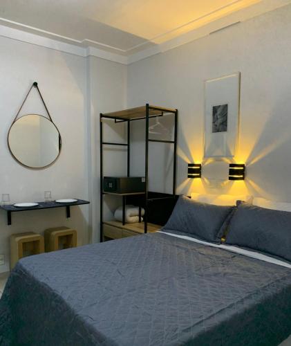 a bedroom with a bed with two lights on it at Lory Studio Hotel in São Paulo