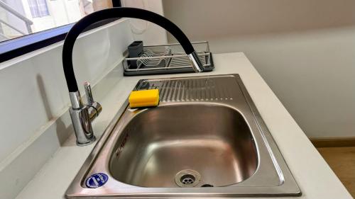 a kitchen sink with a faucet on a counter at Edificio Tofino in Quito