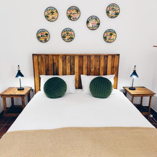 a bedroom with a bed with plates on the wall at Casas da Olaria in Aldeia do Mato
