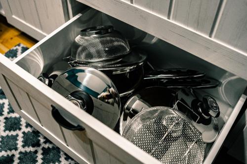 a drawer filled with dishes and utensils in a kitchen at Vilnius Centrum Apartment in Vilnius