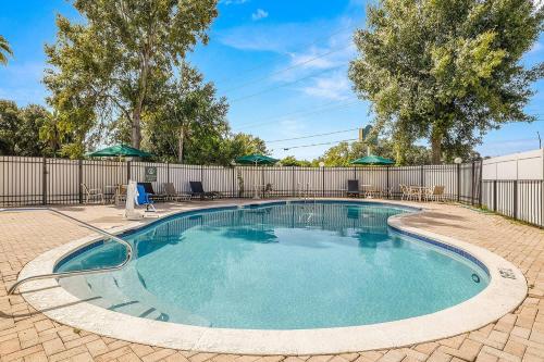 a swimming pool in a yard with a fence at La Quinta by Wyndham Tampa Brandon West in Tampa
