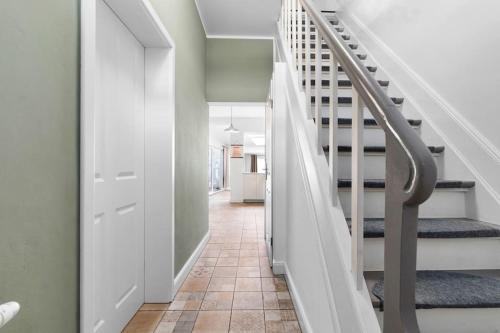 a hallway with stairs in a house at JOOYFUL STAYS Townhouse in Kevelaer