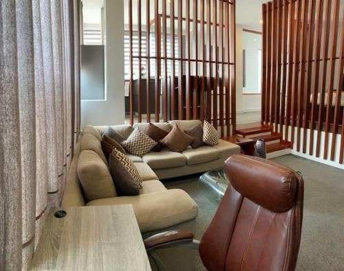 a living room with a couch and a table at Modern One Bedroom Apartment in North ridge in Accra