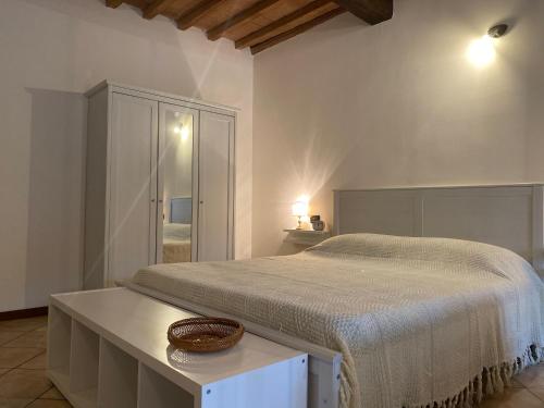 a bedroom with a large bed and a table at Teatro Inn - Timeless Charm in Correggio