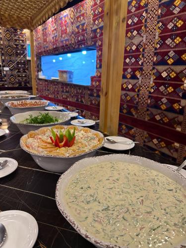 a table with many plates of food on it at Hasan Zawaideh Camp in Wadi Rum