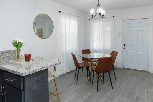 a kitchen and dining room with a table and chairs at A stunning 2bedroom 2bath private home near Sofi Stadium, Kia Forum, and Intuit Dome in Los Angeles