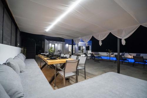 a dining room with a table and a white tent at Montis villa in Daratso