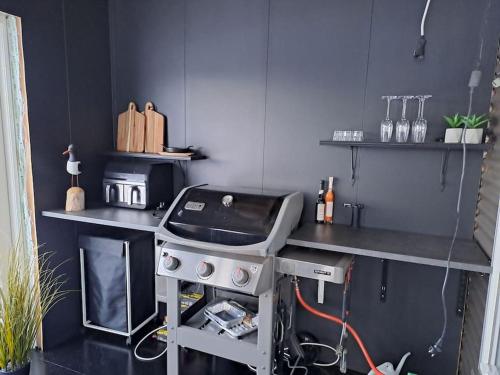 a kitchen with a stove and a counter top at Nýlegur sumarbústaður/friðsæld in Mosfellsbær