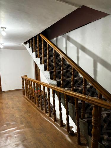 a wooden staircase with a bunch of wine bottles at Al Hayat Guest House in Pahalgām