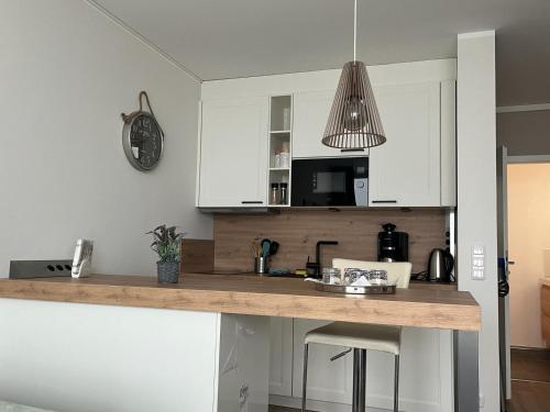 a kitchen with white cabinets and a counter top at Traumwohnung mit Meerblick über die Ostsee in Kiel