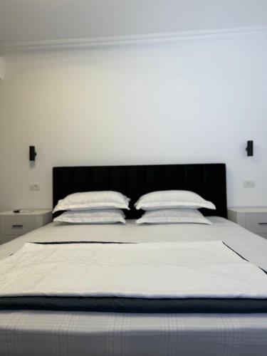 a large bed with two pillows on top of it at Casa Ștefan in Eforie Sud
