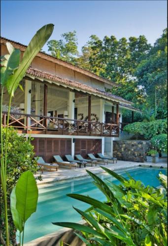 eine Villa mit einem Pool und einem Resort in der Unterkunft The Lake House Koggala in Galle