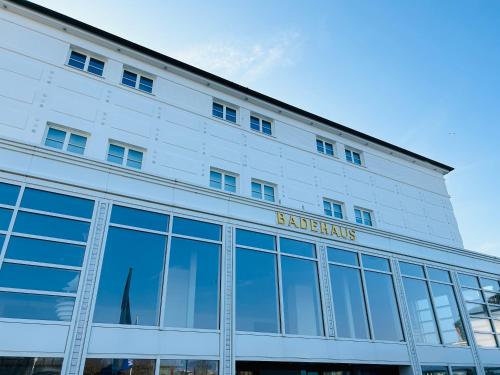 a large white building with a sign on it at Inselliebe Norderney in Norderney