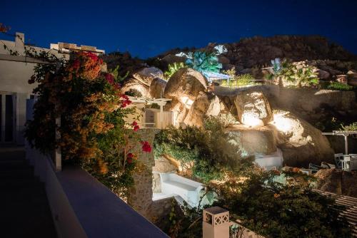 an outdoor garden with flowers and rocks at night at Super Rockies Resort in Super Paradise Beach