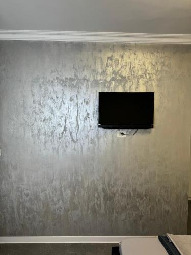 a flat screen tv on a wall at Casa Ștefan in Eforie Sud