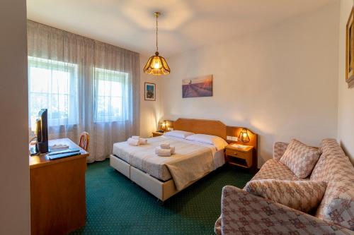 Postel nebo postele na pokoji v ubytování Hotel Ristorante Sagittario