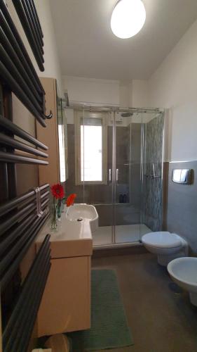 a bathroom with a shower and two sinks and a toilet at Casa Publicola in Rome