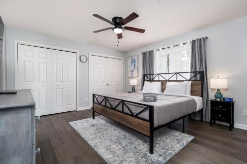 a bedroom with a bed and a ceiling fan at Serenity on the Cove in Dundalk