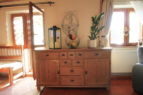a wooden dresser with a mirror on top of it at Eden guest house in Brezno