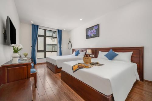 Postel nebo postele na pokoji v ubytování Sea Near Me Hotel Danang