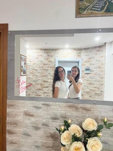 a woman taking a picture of herself in a mirror at Dolce Dormire in Castiglione del Lago