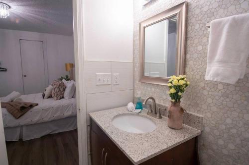 a bathroom with a sink and a mirror and a bed at 5 BR - Sleeps 10! Best Location next to French Quarter! in New Orleans