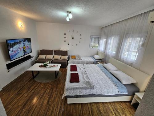 a living room with two beds and a couch at Apartment On the way in Stolac