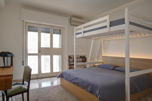 卡塔尼亞的住宿－Top Floor Aparthotel Bentivoglio，一间卧室配有双层床和书桌
