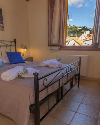 a bedroom with a bed with a large window at B&B Città Regia in Iglesias