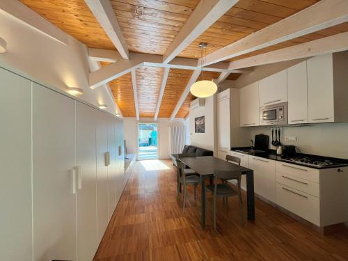 a kitchen and dining room with white cabinets and a table at Ca' del Monica in Manarola