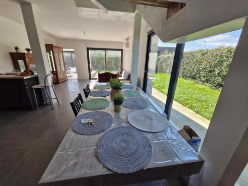 - une grande table avec des assiettes dans une pièce dans l'établissement La Villa Caennaise-Caen, à Caen