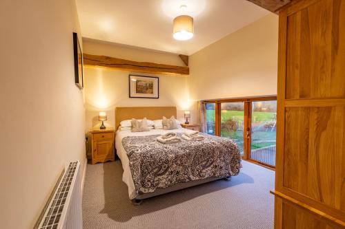 a bedroom with a bed and a balcony at Bullrush Barn, Brecon Beacons walkers retreat in Brecon
