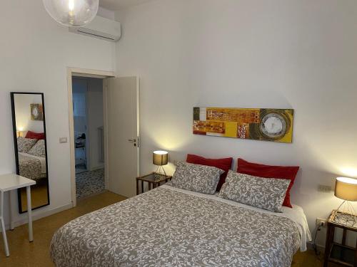 a bedroom with a bed and a clock on the wall at Regina Elena al mare in Pescara