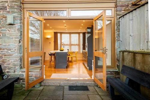 an open door leading to a kitchen and dining room at Bullrush Barn, Brecon Beacons walkers retreat in Brecon
