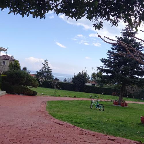 a bike parked on the grass in a yard at TAMMY'S GARDEN HOUSE in Leptokaria