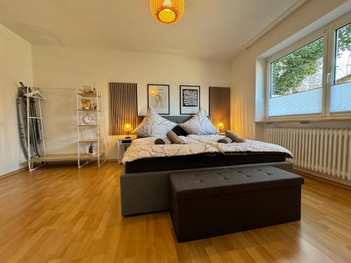 a bedroom with a large bed and a large window at Feel like Home 3 in Biberach an der Riß